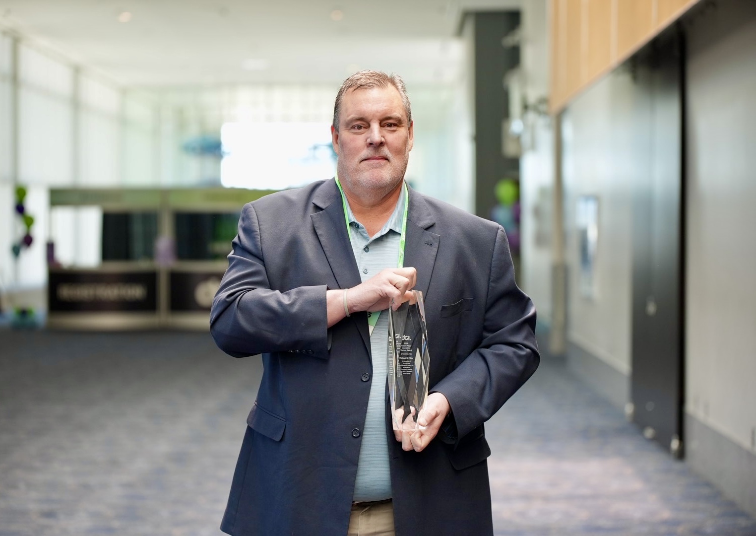 Michael Miller Recipient of 2025 Nation Meyer Innovative Banker Award posing with his award.